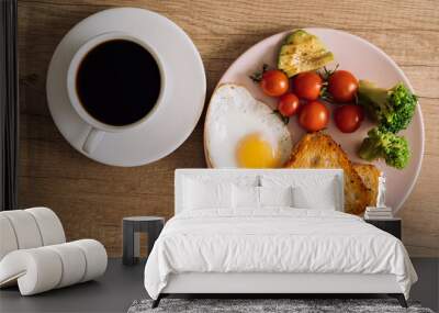 Flat lay homemade breakfast with cup of black coffee, fried egg and toast with tomatoes and avocado on a plate Wall mural