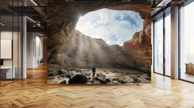 hiker in the ocean cave of Devil's Punch Bowl on the Oregon coast Wall mural