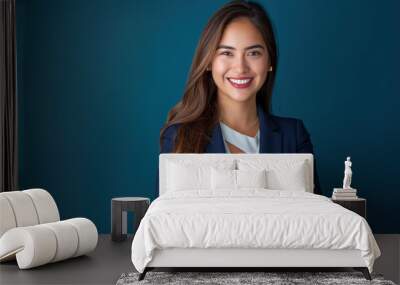  Portrait of smiling business woman in blue suit standing with arms crossed on dark background, confident female executive looking at camera isolated over deep sea color background Wall mural