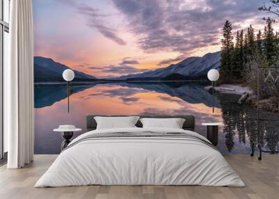 Reflection of early sunrise glowing light on Moncho Lake in the Northern Canadian Rockies Wall mural