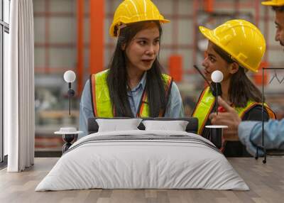 two female mechanical engineers from different ethnicities and cultures having a discussion over a p Wall mural