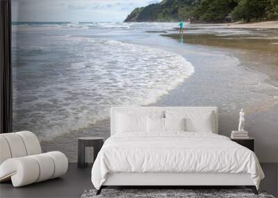 White bubbles from sea wave at a clean tropical beach on sunny day Wall mural