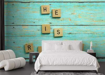 He is Risen Christian blocks on a blue wood plank background Wall mural