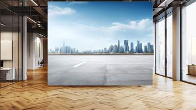 Concrete road with city skyline on background Wall mural