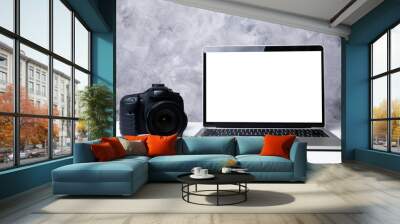 A black digital camera and a computer laptop on a table Wall mural