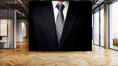 Close up of man in black suit, shirt and tie on black background Wall mural