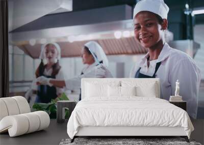 Group of schoolgirls having fun learning to cook. Female students in a cooking class. Wall mural