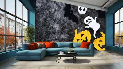 Halloween concept with pumpkins, ghosts and bats cut paper on black concrete background. Wall mural