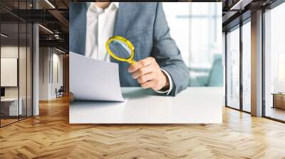 businessman or tax inspector analyzing document with magnifying glass in office. business financial audit concept. copy space Wall mural