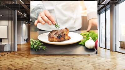 chef decorating roasted meat with herbs Wall mural