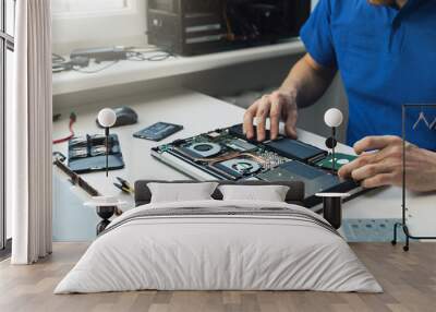 computer repairman installing new hard disk drive in laptop Wall mural