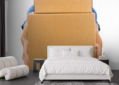 delivery man holding pile of cardboard boxes in front Wall mural