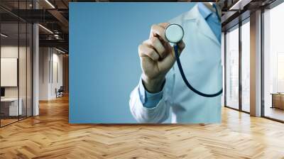 healthcare and medicine - doctor in white coat holding stethoscope on blue background. copy space Wall mural