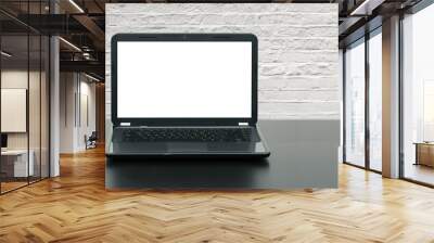 laptop with blank screen on wooden table at brick wall Wall mural