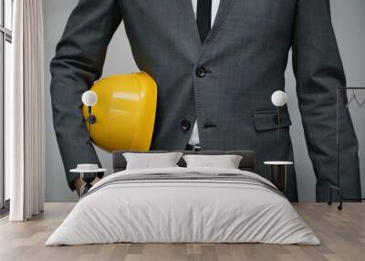 safety at work or construction business concept - businessman holding yellow helmet underarm Wall mural