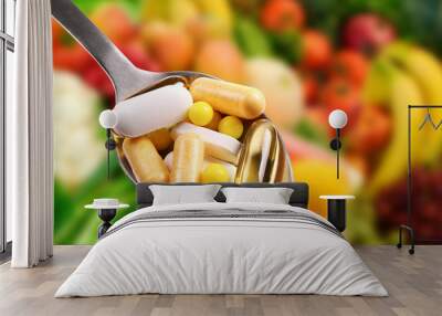 spoon with dietary supplements on fruits background Wall mural