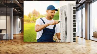 technician working on house air conditioning or heat pump outdoor unit. HVAC service, maintenance and repair. banner with copy space Wall mural