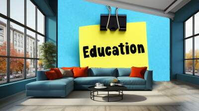 EDUCATION word on a small yellow sheet of paper. Wall mural