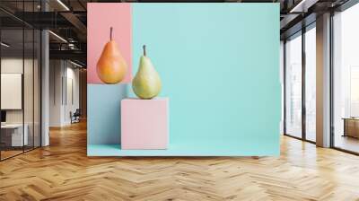 Artistic composition of two pears balanced on minimalist blocks against a pastel background. Wall mural