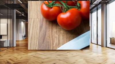 Fresh and tasty tomatoes with knife on a wooden table Wall mural