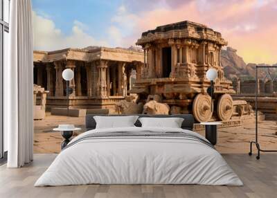 Famous ancient stone chariot of Hampi in closeup view with other architecture ruins at Karnataka, India, at sunset.  Wall mural