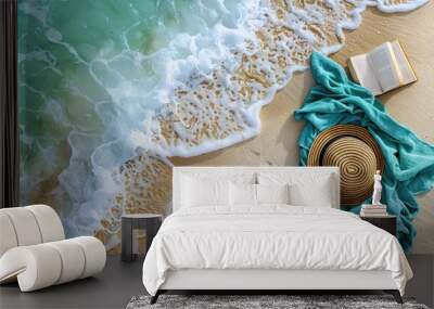 Relaxing beach scene with straw hat, aqua marine towel, and a serene book Wall mural