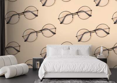 Eyeglasses pattern on a beige background. Creative fashion layout. Wall mural