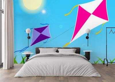 pair of colorful kites fly on blue sky during a sunny day Wall mural