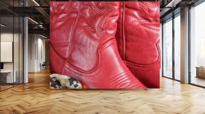 close up on a pair of red cowboy style cowgirl western boots with a southwest pattern scarf Wall mural