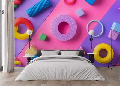 A variety of toy blocks and rings are on the floor of a preschool isolated on purple and pink background Wall mural