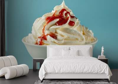 bowl of whipped cream with red sauce on blue background Wall mural