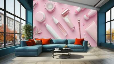 Overhead view of set female essential beauty items on pink flat lay Wall mural