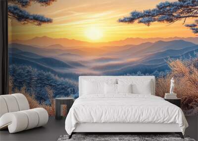 Stunning sunrise over a tranquil snowy winter landscape in the mountains with frost-covered trees and misty valleys below Wall mural