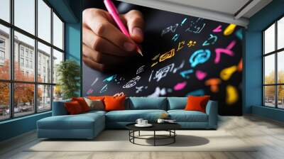 A close-up of a hand drawing colorful doodles on a black surface, showcasing creativity and artistic expression. Wall mural