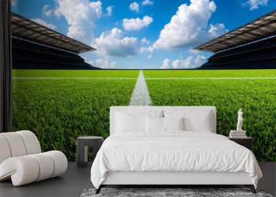 A vibrant football field with lush green grass beneath a blue sky, perfect for sports events and outdoor activities. Wall mural