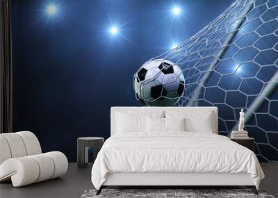 Soccer ball flew into the goal. Soccer ball bends the net, against the background of flashes of light. Soccer ball in goal net on blue background. A moment of delight. 3D illustration Wall mural