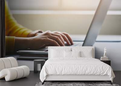 Close up of female hands while typing on laptop Wall mural