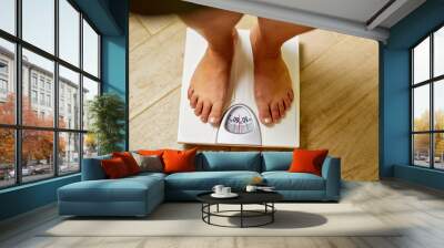 Top view of female bare feet on weight scale in a bathroom Wall mural