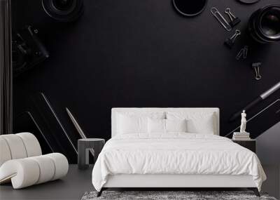 Top view of the black table graphic designer with camera, lenses and diary with copy space. Flat lay shot Wall mural