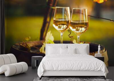 Two full glasses of white wine on wooden barrel in autumn Wall mural