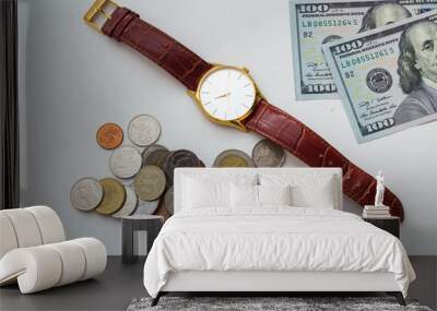 Time is money. Wrist watch with dollar bills and coins on a white background. Wall mural