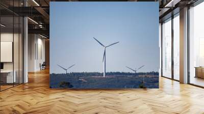 Windmills for electric power production on hill Wall mural