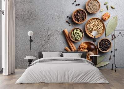 A variety of whole Indian spices in wooden bowls on a gray background with copyspace top view Wall mural