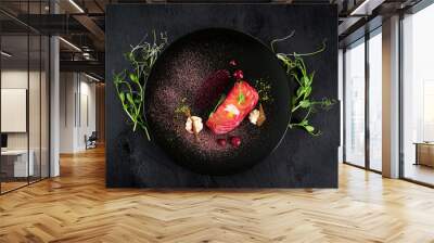 Red fish salmon dish with sauce on black background Wall mural