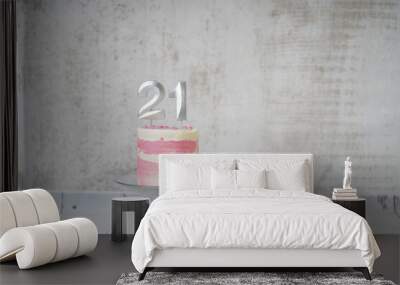 21st Birthday cake pink and silver cake with some sprinkles and 21st candlelight on a white wooden background.                                Wall mural