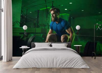 a man in the gym pushes the bar Wall mural