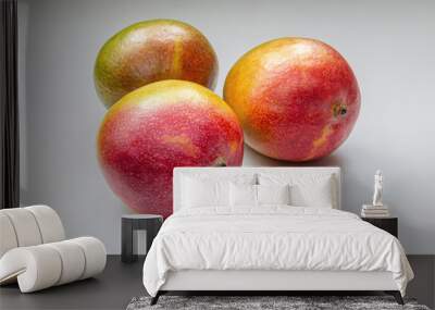 Ripe, juicy tropical mangoes on a light gray surface Wall mural