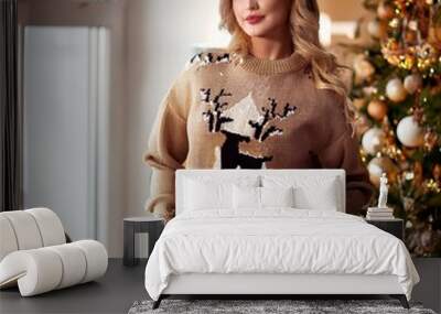 elegant young blonde Caucasian woman wearing heavy sweater, Chri Wall mural