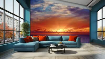 Beautiful colorful sunset at the sea with dramatic clouds and sun shining. Beauty world natural outdoors travel background Wall mural