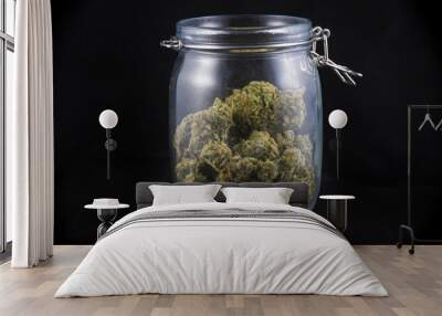 Cannabis bud in a glass jars isolated on black - medical marijua Wall mural